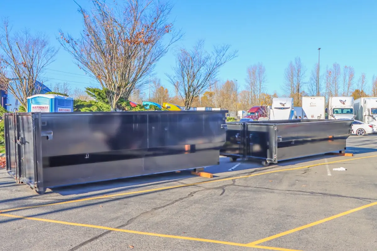 Professional dumpster rental service with roll-off container on residential driveway in Long Beach